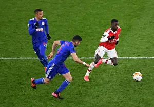 Arsenal V Olympiacos 2019-20 Prints: Pepe vs. Bouchalakis: Intense Clash in Arsenal's Europa League Battle against Olympiacos