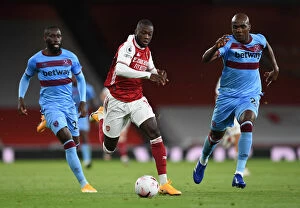 Arsenal v West Ham United 2020-21 Collection: Pepe vs Ogbonna: Intense Face-Off in Arsenal's Battle Against West Ham