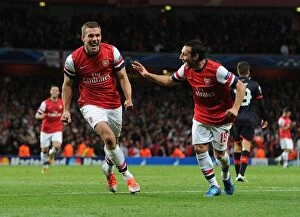 Uefa Champions Laegue Collection: Podolski and Cazorla Celebrate Arsenal's Second Goal vs. Olympiacos (2012-13)