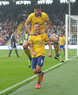 Fulham F C Prints: Podolski and Giroud's Euphoric Moment: Arsenal's Third Goal Against Fulham (2013-14)
