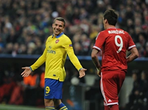 Bayern Munich V Arsenal 2013-14 Prints: Podolski and Mandzukic Share a Laugh: Bayern Munich vs