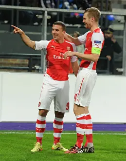 Podolski and Mertesacker Celebrate Arsenal's Second Goal Against Anderlecht in 2014-15 Champions League