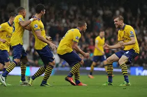 Fulham F C Prints: Podolski and Mertesacker Celebrate Arsenal's Winning Goals Against Fulham (2013-14)