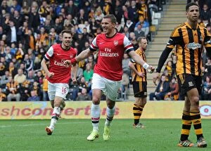 Hull City Collection: Podolski and Ramsey Celebrate Arsenal's Victory: Hull City vs Arsenal, Premier League 2013/14