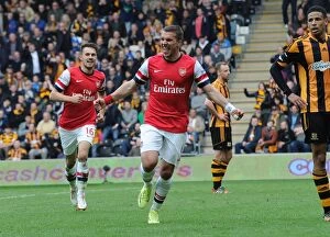 Images Dated 20th April 2014: Podolski and Ramsey Celebrate Arsenal's Winning Goals vs Hull City (2014)