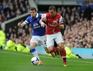 Everton v Arsenal 2013/14 Collection: Podolski vs. Coleman: Intense Battle at Goodison Park - Everton vs. Arsenal, Premier League 2013/14