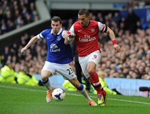 Everton v Arsenal 2013/14 Collection: Podolski vs. Coleman: A Premier League Showdown at Goodison Park