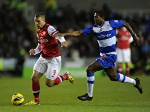 Reading V Arsenal 2012-13 Prints: Podolski vs. Leigertwood: Battle at the Madejski Stadium - Reading v Arsenal