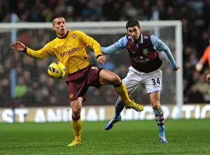 Aston Villa V Arsenal 2012-13 Prints: Podolski vs. Lowton: A Battle at Villa Park - Arsenal vs