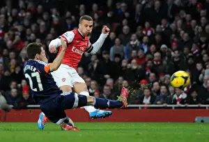 Arsenal V Fulham 2013-14 Prints: Podolski vs. Riether: Intense Moment at Arsenal v Fulham, Premier League