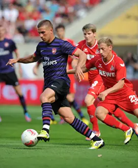 Cologne V Arsenal 2012-13 Prints: Podolski vs. Royer: Clash of the Forwards in Arsenal's Pre-Season Friendly against Cologne (2012)
