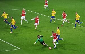 Images Dated 24th January 2014: Podolski's Dramatic FA Cup Goal: Outmaneuvering Murphy for Arsenal's Victory over Coventry City