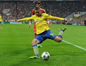 Bayern Munich v Arsenal 2013-14 Collection: Podolski's Return: A Bayern Munich Legend Haunts Old Team in Champions League Showdown - Arsenal vs