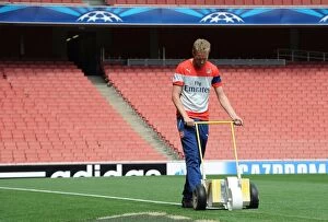 Images Dated 27th August 2014: Preparing for Champions League: Arsenal's Meticulously Marked Emirates Stadium Pitch (2014/15)
