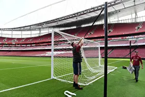 Preparing Emirates Stadium: Arsenal's Grounds Team Readies the Field for Arsenal vs. Fulham (2023-24)