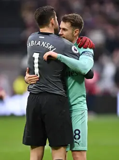 West Ham United V Arsenal 2018-19 Prints: Ramsey and Fabianski Reunite: A Heartfelt Embrace at West Ham vs Arsenal