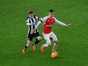 Arsenal v Newcastle United 2015-16 Collection: Ramsey Stands Firm: Arsenal's Midfielder Fends Off Newcastle's Colback in Intense Premier League