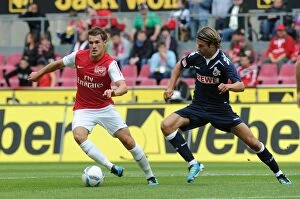 Cologne v Arsenal Collection: Ramsey Takes on Lanig: Cologne vs Arsenal Pre-Season Clash