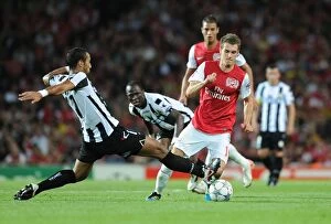 Arsenal v Udinese 2011-12 Collection: Ramsey vs. Benatia: A Champion's Battle in Arsenal's 2011 Champions League Showdown