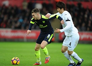 Swansea City V Arsenal - 2016-17 Prints: Ramsey vs. Ki: Intense Battle in Swansea City vs. Arsenal Premier League Clash