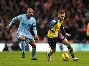 Images Dated 18th January 2015: Ramsey's Unstoppable Sprint: Outpacing Fernando (Manchester City vs. Arsenal, 2014-15)
