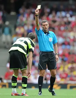 Arsenal V Celtic 2010-11 Prints: Referee Andre marriner shows a yellow card to Charlie Mulgrew (Celtic)