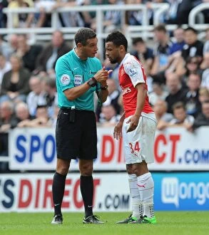 Newcastle United v Arsenal 2015-16 Collection: Referee Intervenes in Heated Coquelin-Newcastle Clash during Arsenal vs. Newcastle Match