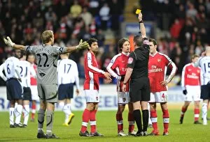 Bolton v Arsenal 2009-10 Collection: Referee Phil Dowd shows the yellow card to Arsenals Tomas Rosicky