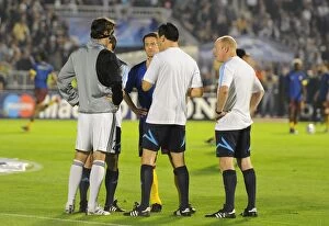Referee Wolfgang Stark with Arsenal captain Tomas Rosicky and Patrizan captain Mladen Krstajic