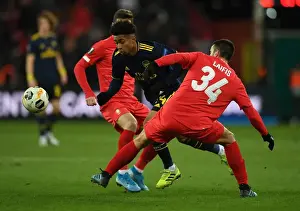Standard Liege V Arsenal 2019-20 Prints: Reiss Nelson Darts Past Kostas Laifis: Arsenal's Europa League Battle at Standard Liege