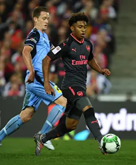 Sydney FC V Arsenal - 2017-18 Prints: Reiss Nelson vs. Brandon O'Neill: A Riveting Battle in the Sydney FC vs