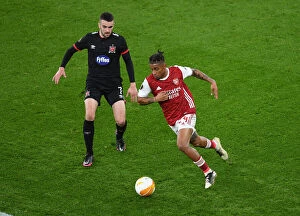 Images Dated 29th October 2020: Reiss Nelson vs. Michael Duffy: A Rivalry Unfolds in Empty Emirates Stadium - UEFA Europa League