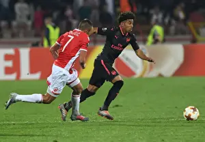 Red Star Belgrade V Arsenal 2017-18 Prints: Reiss Nelson vs Nenad Krsticic: Battle at Rajko Mitic Stadium - Arsenal vs Crvena Zvezda