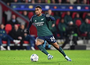PSV Eindoven v Arsenal 2023-24 Collection: Reiss Nelson's Thrilling Dash: Arsenal's Star Forward Outmaneuvers PSV Eindhoven's Defense in