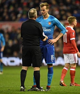 Nottingham Forest V Arsenal FA Cup 3rd Round 2017-18 Prints: Rob Holding in Deep Conversation with Referee John Moss during Nottingham Forest vs Arsenal FA Cup Clash