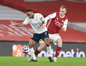 Rob Holding vs Raheem Sterling: A Premier League Battle in Empty Emirates Stadium During Coronavirus Restrictions