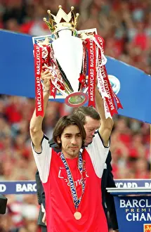 Robert Pires lifts the F. A. Barclaycard Premiership Trophy