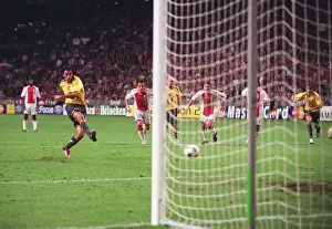 Robert Pires shoots past Ajax goalkeeper Hans Vonk to score the 2nd Arsenal goal from the penalty sp