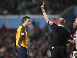 Robin van Persie (Arsenal) is booked by referee Lee Mason