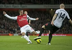 Robin van Persie of Arsenal breaks shoots Philippe Senderos of Fulham during the Barclays Premier League match between