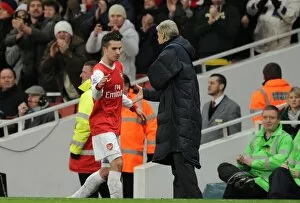 Robin van Persie (Arsenal) is congratulated by Manager Arsene Wenger on his hat trick as he is subbed