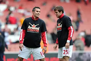 Robin van Persie and Carl Jenkinson (Arsenal) warm up in thier Arsenal for Everyone T Shirt