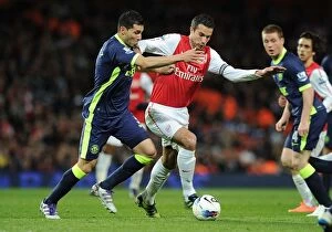 Images Dated 16th April 2012: Robin van Persie Outmaneuvers Antolin Alcaraz in Arsenal's Victory over Wigan Athletic