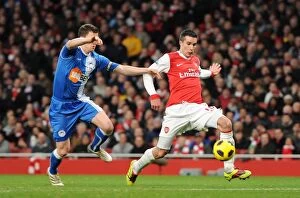 Arsenal v Wigan Athletic 2010-11 Collection: Robin van Persie scores his and Arsenals 2nd goal under pressure from Gary Caldwell