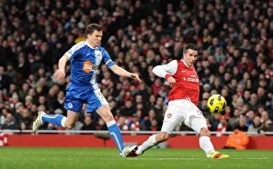 Arsenal v Wigan Athletic 2010-11 Collection: Robin van Persie scores his and Arsenals 2nd goal under pressure from Gary Caldwell