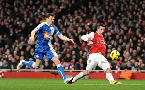 Arsenal V Wigan Athletic 2010-11 Prints: Robin van Persie scores his and Arsenals 2nd goal under pressure from Gary Caldwell