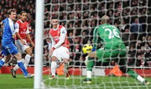 Robin van Persie scores his and Arsenals 3rd goal past Ali Al Habsi (Wigan)