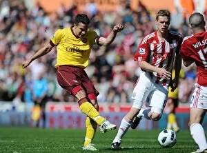 Stoke City v Arsenal 2010-11 Collection: Robin van Persie shoots past Asmir Begovic to score the Arsenal goal. Stoke City 3