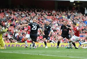 Robin van Persie shoots past Aston Villa goalkeeper Brad Friedel to score the Arsenal goal