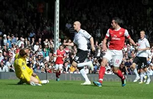 Fulham v Arsenal 2010-11 Collection: Robin van Persie shoots past Fulham goalkeeper Mark Schwarzer to score the 1st Arsenal goal